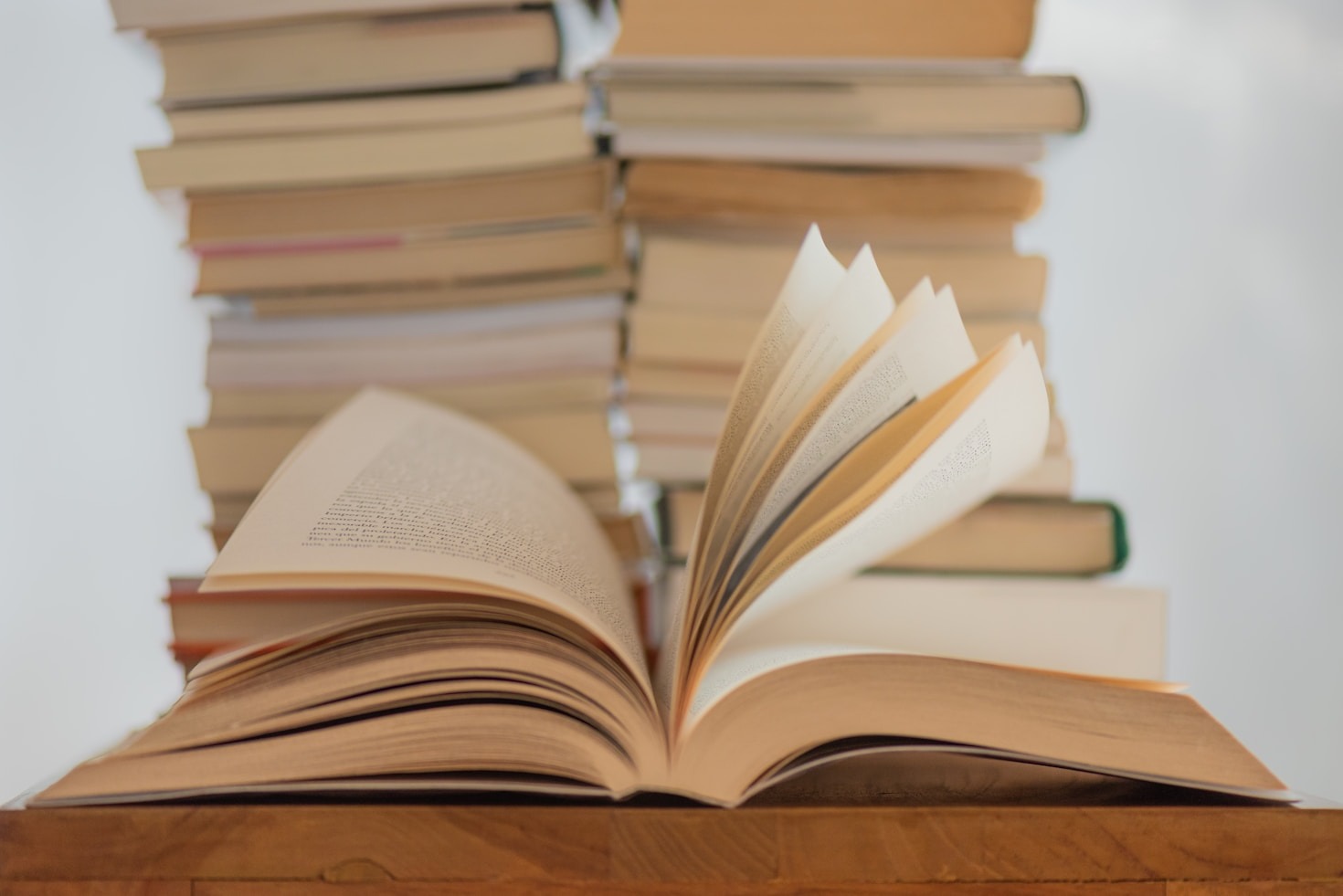 open book with books stacked in background